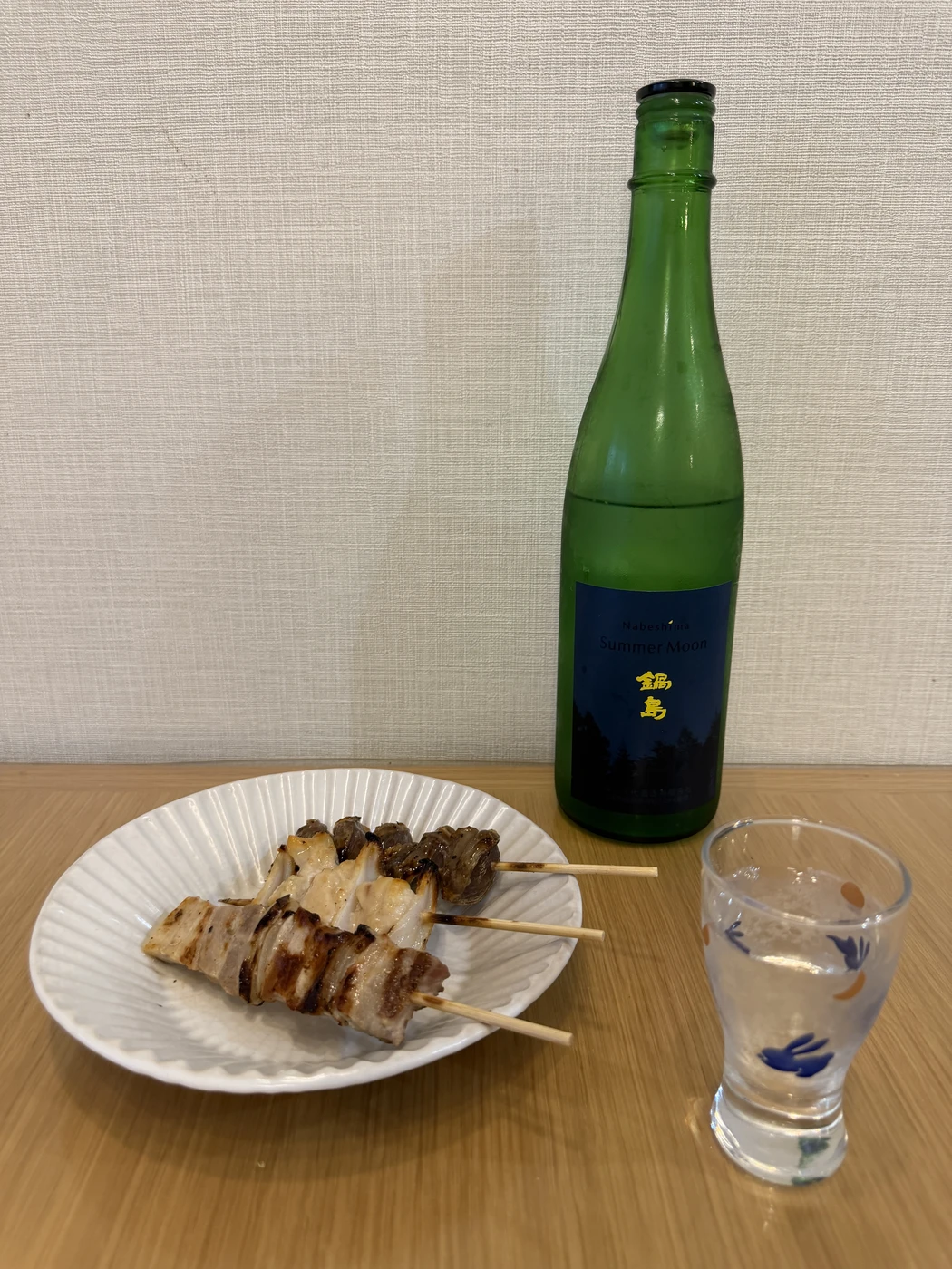 Nabeshima Summer Moon sake paired with grilled chicken and pork yakitori skewers